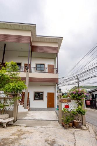 a house with plants in front of it at 94Home Donmuang in Bang Khen