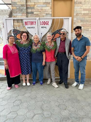 a group of people standing in front of a store at Butterfly Lodge in Pokhara