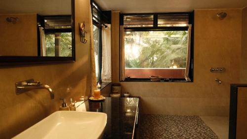 a bathroom with a tub and a sink and a window at SeaEsta Beach House in Pāngāla