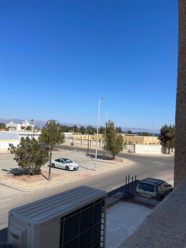 a street with two cars parked in a parking lot at RoseVilla روزفيلا in Ḩaql