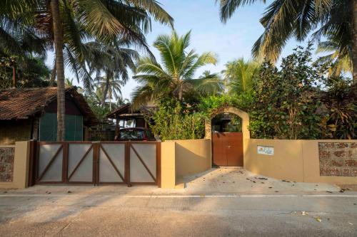 a gate to a house with palm trees at SeaEsta Beach House in Pāngāla