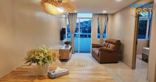 a living room with a table and a chair at Triima Inn Dayang Bay by Perfect Host in Kuah