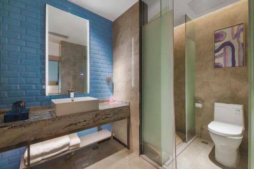 a bathroom with a sink and a toilet at Echarm Hotel Changsha Wuyi Square Xiangya Affiliated 1st Provincial Maternity and Child in Changsha