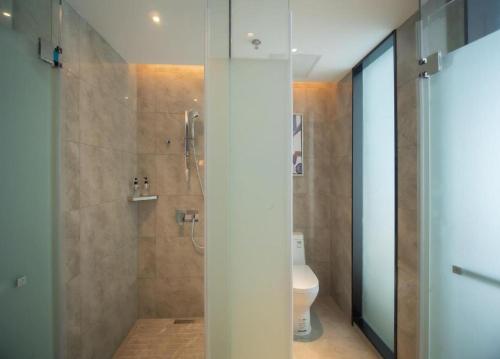 a bathroom with a shower and a toilet at Echarm Hotel Changsha Wuyi Square Xiangya Affiliated 1st Provincial Maternity and Child in Changsha