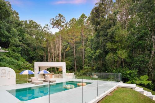 a swimming pool in a backyard with trees at Casa Campana By Khove in Clothiers Creek