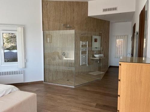a bathroom with a glass shower and a sink at Villa Eirini Kamares Tala Luxury Sea View in Tala