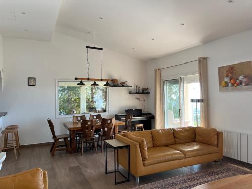 a living room with a couch and a dining room at Villa Eirini Kamares Tala Luxury Sea View in Tala