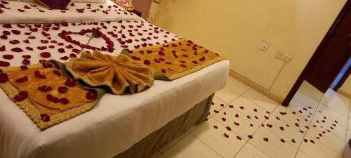 a bedroom with a bed with red hearts on it at Lotus Furnished Hotel Apartments LLC. Ajman in Ajman 