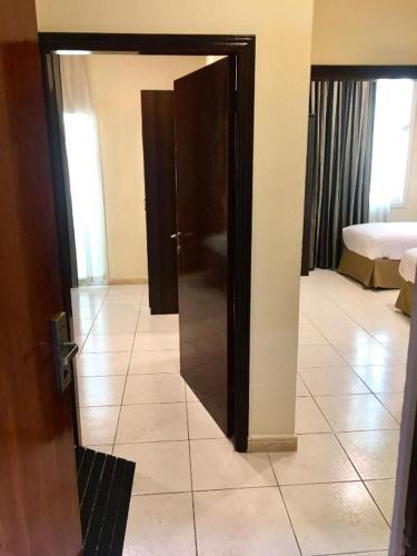 an open door to a room with a bedroom at Lotus Furnished Hotel Apartments LLC. Ajman in Ajman 