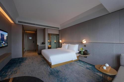Ένα ή περισσότερα κρεβάτια σε δωμάτιο στο Onejee Hotel Shenzhen