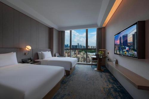 Ένα ή περισσότερα κρεβάτια σε δωμάτιο στο Onejee Hotel Shenzhen