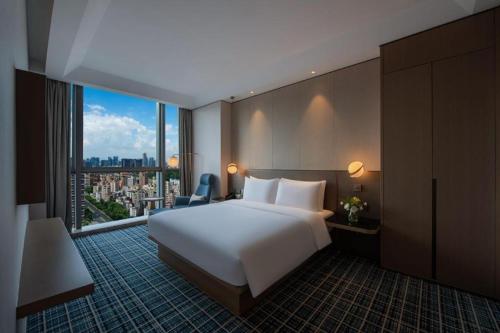 Ένα ή περισσότερα κρεβάτια σε δωμάτιο στο Onejee Hotel Shenzhen