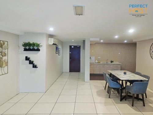 a dining room and kitchen with a table and chairs at Triima Inn Dayang Bay by Perfect Host in Kuah