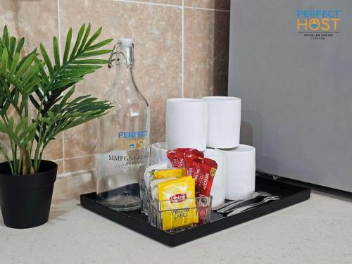 a black tray with toiletries and a bottle on a counter at Triima Inn Dayang Bay by Perfect Host in Kuah
