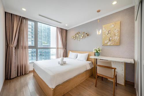 a bedroom with a bed and a desk and a window at Saigon Landmark Cityview Apartment - PYG in Ho Chi Minh City