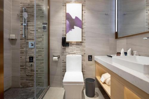 a bathroom with a toilet and a sink and a shower at Lavande Hotel Guangzhou Quzhuang Metro Station in Guangzhou