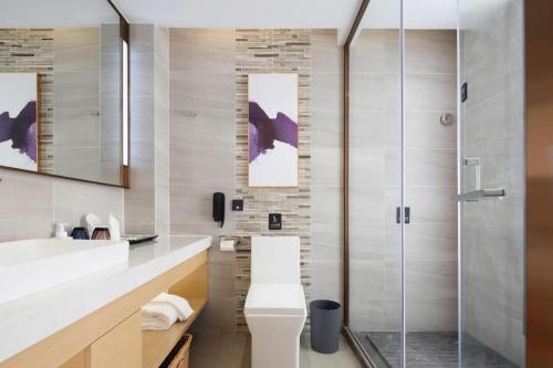 a bathroom with a toilet and a shower at Lavande Hotel Guangzhou Quzhuang Metro Station in Guangzhou