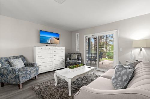 a living room with a couch and a table at Modern Retreat in Charleston