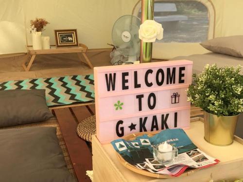 a welcome to gk sign on a table in a room at Glamping kaki singapore-Standard medium bell tent in Singapore