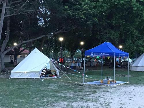 a group of tents in a park at night at Glamping kaki singapore-Standard medium bell tent in Singapore