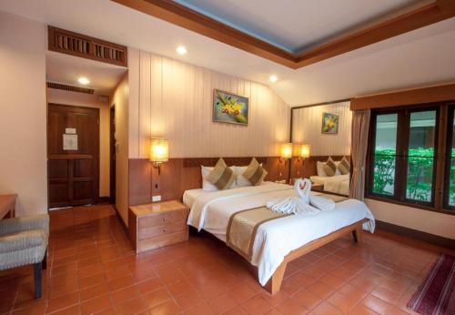 a bedroom with a large bed and a couch at Privacy Beach Resort & Spa in Ban Nong Khao Nieo