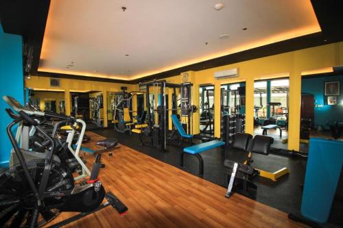 a gym with several treadmills and machines in a room at Grand Surya Hotel Kediri in Kediri