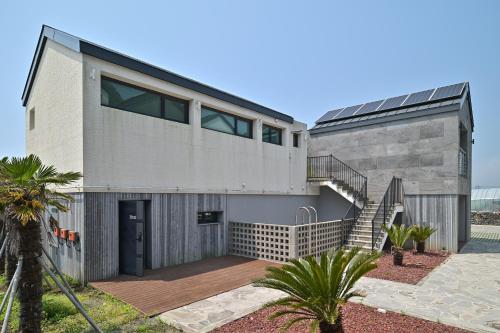 an image of a house with a staircase at Masion Sanbang Jeju in Seogwipo