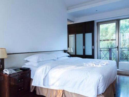 Postel nebo postele na pokoji v ubytování Xiamen SIG Resort