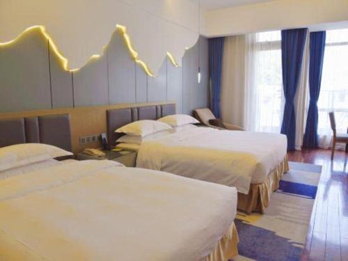 Postel nebo postele na pokoji v ubytování Xiamen SIG Resort