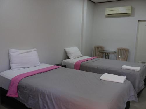 a room with two beds and a table and chairs at Suanlamyai Resort in Loei