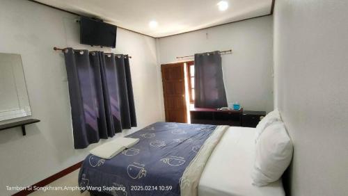a bedroom with a bed and a window with curtains at Suanlamyai Resort in Loei