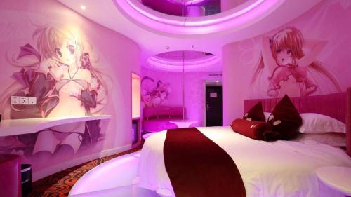 a purple bedroom with a bed with two girls on it at Grand Nest Hotel (Tang Jia Wan Beach) in Zhuhai