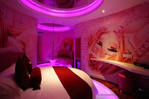 a bedroom with a bed with a painting on the wall at Grand Nest Hotel (Tang Jia Wan Beach) in Zhuhai