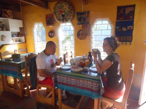 a man and a woman sitting at a table at La Casa Amarilla in Baños