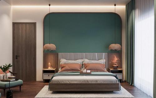 a bedroom with a large bed with a blue wall at Sunrise Mountain View Resort in Vang Vieng