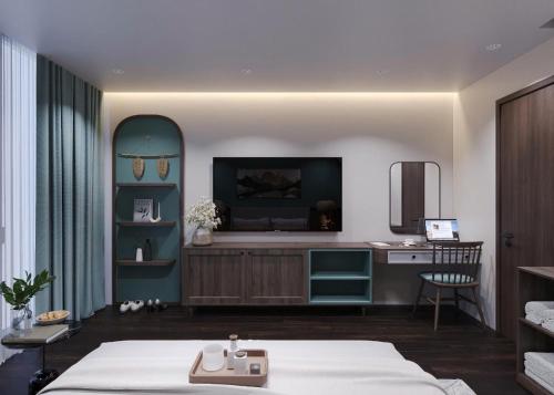 a bedroom with a bed and a desk in a room at Sunrise Mountain View Resort in Vang Vieng