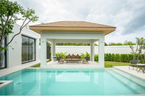 a house with a swimming pool with a gazebo at Mouana Residence Song Khun Chalong 5-bedroom Pool Villa 89-11 in Chalong 