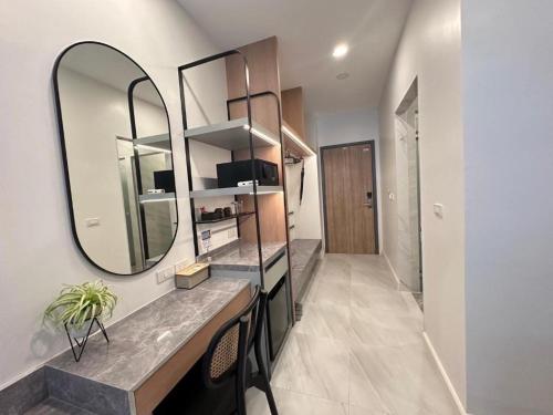 a bathroom with a large mirror on the wall at Royal Hills Golf Resort and Spa in Ban Som Phung Haeng (1)