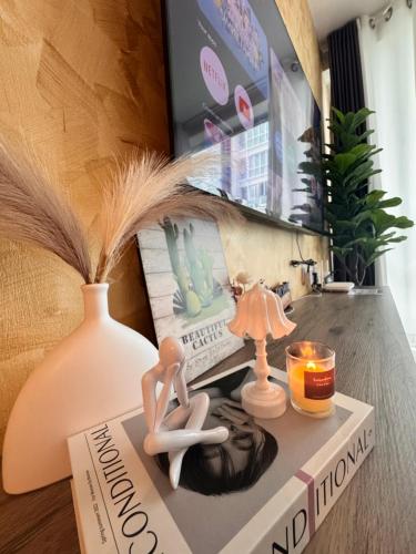 a book sitting on a table with a lamp and a lamp at MetroCity Square Condominium-3R2B-9 Pax in Kuching
