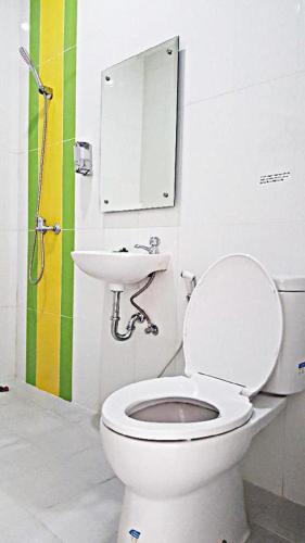 a bathroom with a toilet and a sink at Mitra Hotel Yogyakarta in Yogyakarta