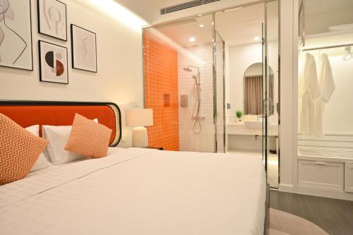 a bedroom with a large bed and a shower at Hillside Luxury Phu Quoc Apartment in Phu Quoc
