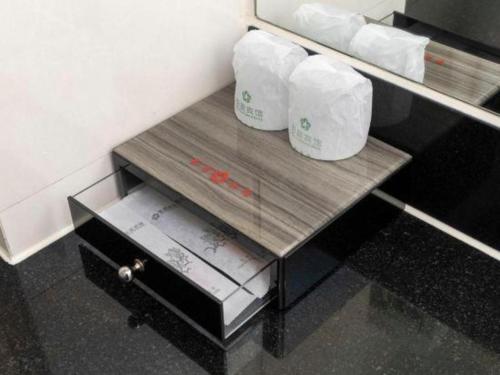 a table with two rolls of toilet paper on it at Movie Star Hotel in Guangzhou