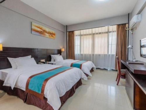 a hotel room with two beds and a sink at Movie Star Hotel in Guangzhou