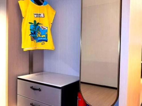 a yellow shirt and a mirror in a room at Movie Star Hotel in Guangzhou