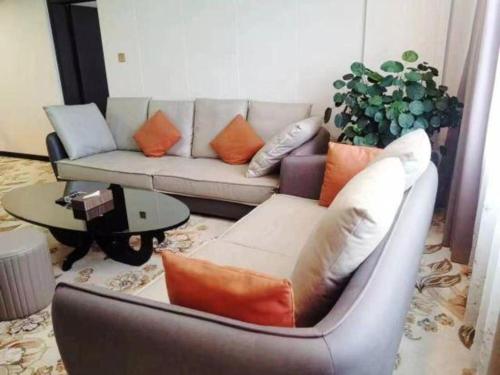 a living room with a couch and a table at Movie Star Hotel in Guangzhou