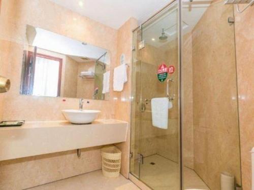 a bathroom with a sink and a shower at GreenTree Alliance Zhejiang Zhoushan Putuoshan Zhujiajian Scenic Spot Hotel in Zhoushan