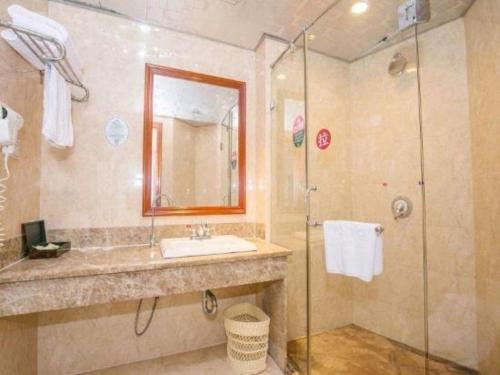 a bathroom with a sink and a shower at GreenTree Alliance Zhejiang Zhoushan Putuoshan Zhujiajian Scenic Spot Hotel in Zhoushan