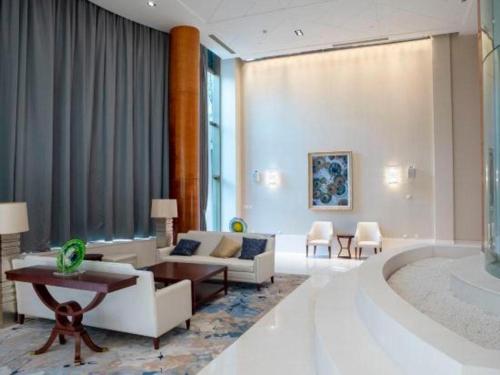 a living room with a couch and a tub at Suzhou Jinji Lake Grand Hotel in Suzhou