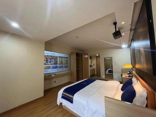 a bedroom with a large bed and a flat screen tv at IU Hotel Chengdu High-Tech Zone Longhu Times Street in Chengdu