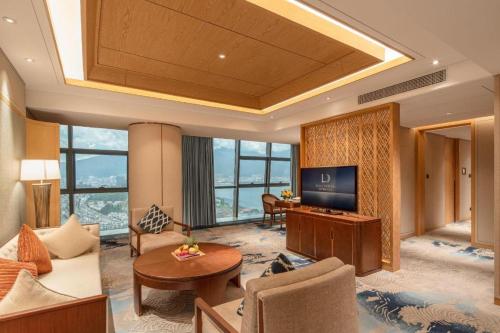 a living room with a large room with a television at Dali Hotel in Dali
